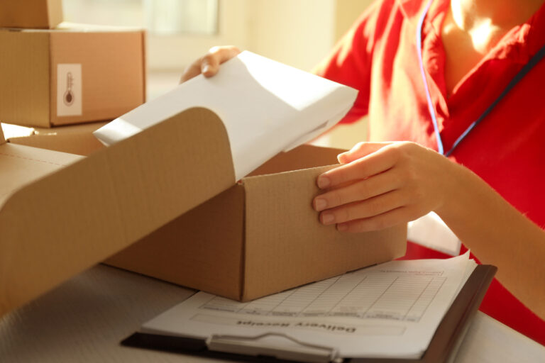 worker packing subscription box in warehouse