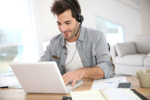 man working from home on a desk in living room