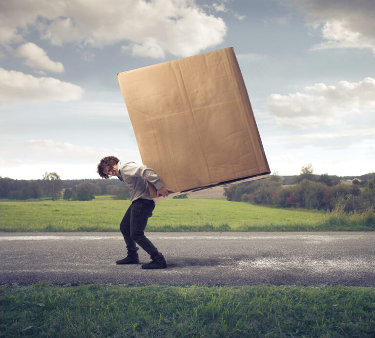 man carrying large package on his back