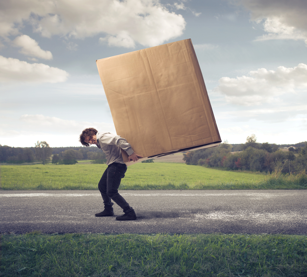 man carrying large package on his back