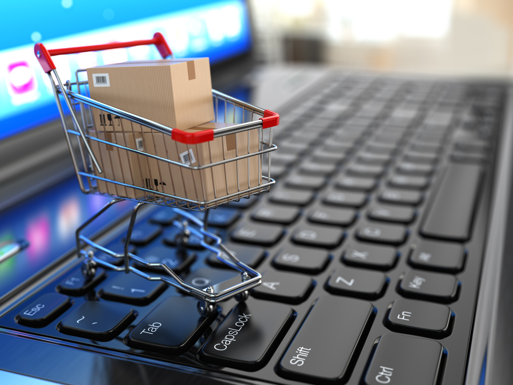 miniature shopping cart on top of computer keyboard