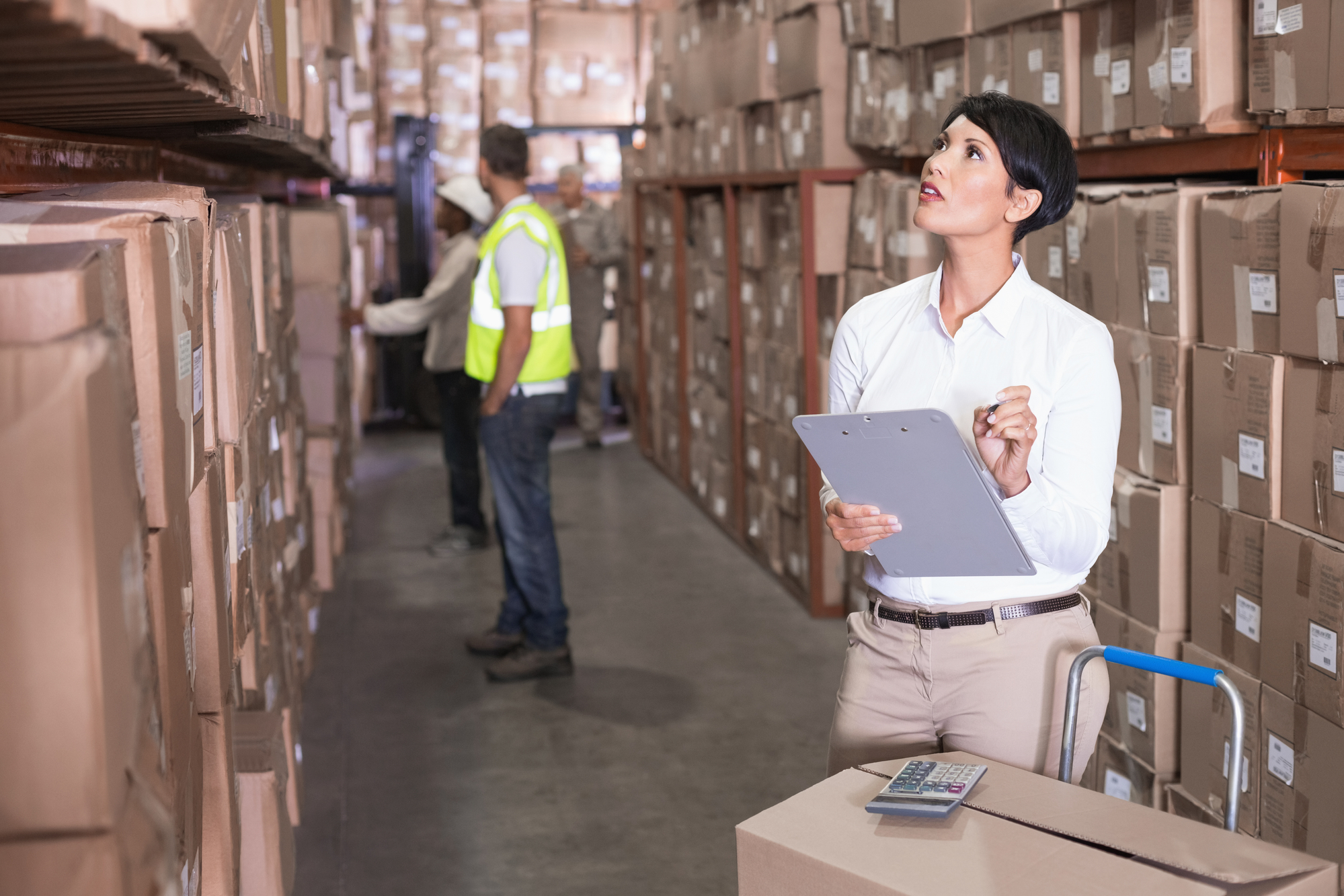 woman in warehouse inspecting inventory