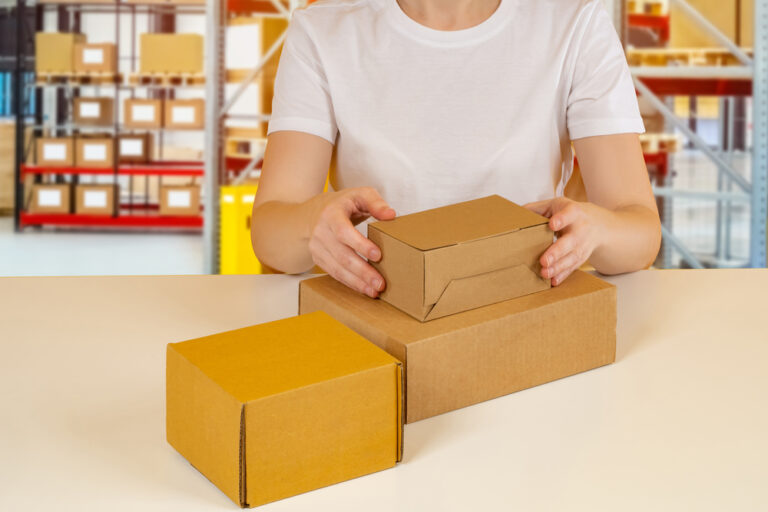 Warehouse employee working. Cardboxes on desk of warehouse employee. Concept - processing or shipment of orders. Shipment of goods from the warehouse. Various boxes in front of sorter.