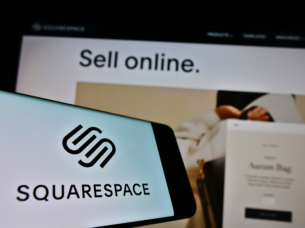 Squarespace Inc. on screen in front of website. Focus on center-right of phone display.