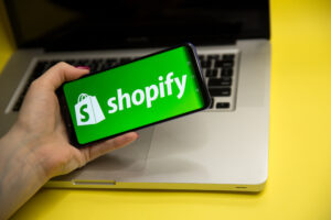 Shopify logo displayed on a modern smartphone